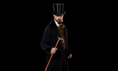 A man in a top hat and tails holding a cane