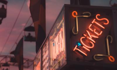 A building with a neon 'tickets' light.