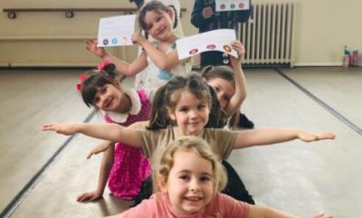 A Firebird Youth Dance class smiling and showing off their certificates.