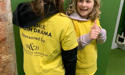 Two kids wearing yellow t-shirts with sponsorship from Whitehill & Bordon regeneration company