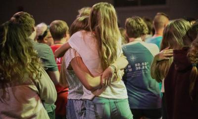 A group of young people hugging and vibing