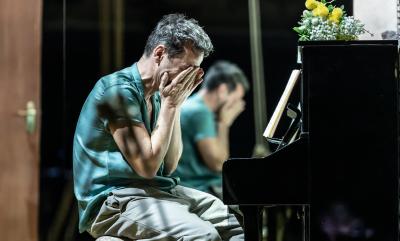 Andrew Scott in Vanya sat at a piano with his head in his hands