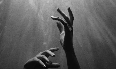 hands reaching up to the sky