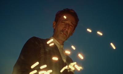 A man smoking with sparks flying around him