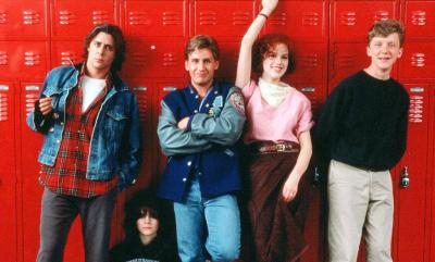The Breakfast Club cast standing by some red lockers