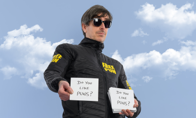 Darren Walsh holding cue cards that say Do You Like Puns?