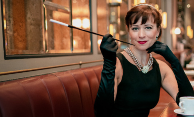 A woman dressed as Audrey Hepburn in a cafe