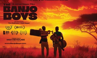 A bright red sky with the silhouettes of two men