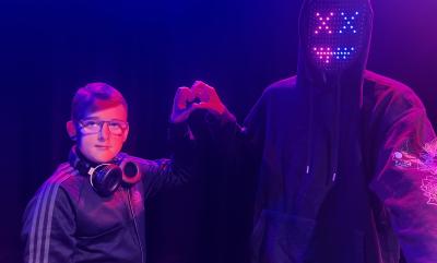 Two DJs making a heart with their hands