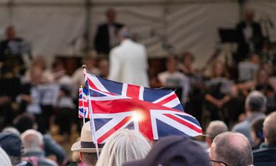 A crowd with an audience in the background and the union jack