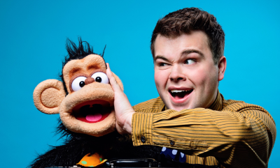 A man and a monkey puppet