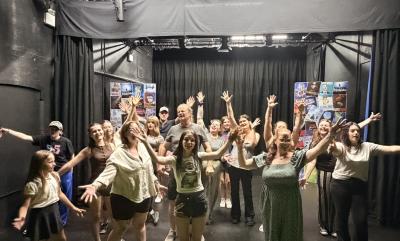 A group of people smiling and dancing