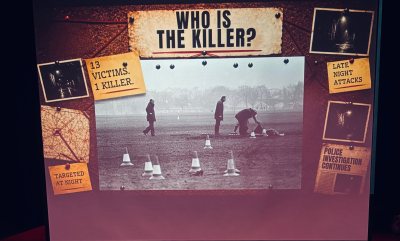 A backdrop with who is the killer on it
