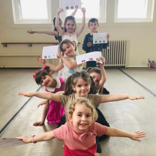 A Firebird Youth Dance class smiling and showing off their certificates.