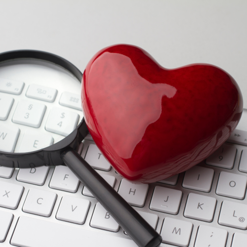 a heart and magnifier on a keyboard