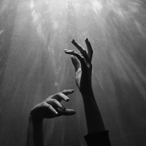 hands reaching up to the sky
