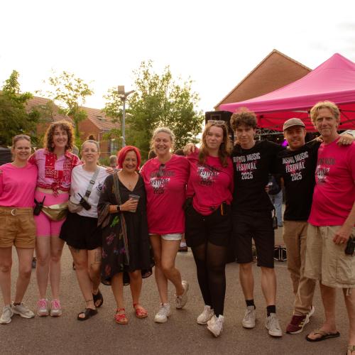 A team of people in Rising Music Festival t-shirts